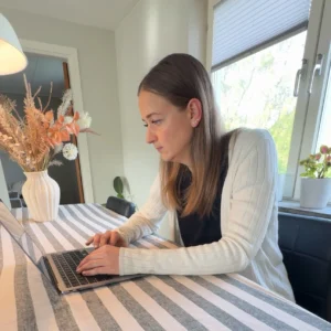 Sophie arbetar fokuserat vid en laptop med att bygga hemsida.